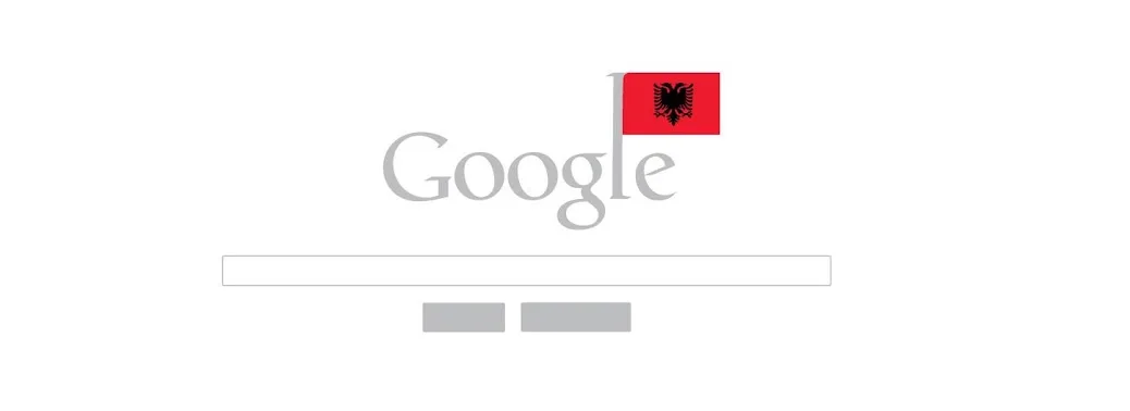 A mockup of the Google homepage with a small Albanian flag, its double-headed eagle visible, planted above the logo like a pennant on a pole, the search box and the two buttons underneath left plain and grey.